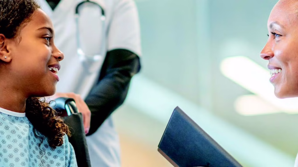 Doctor talking to a patient on a wheelchair.